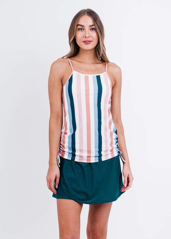 Girl wearing striped spaghetti strap swim top with dark jade wrap swim skirt