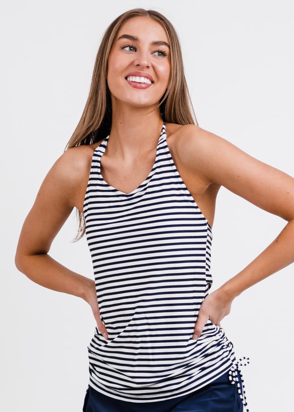Smiling woman wearing halter navy and white stripes swim top