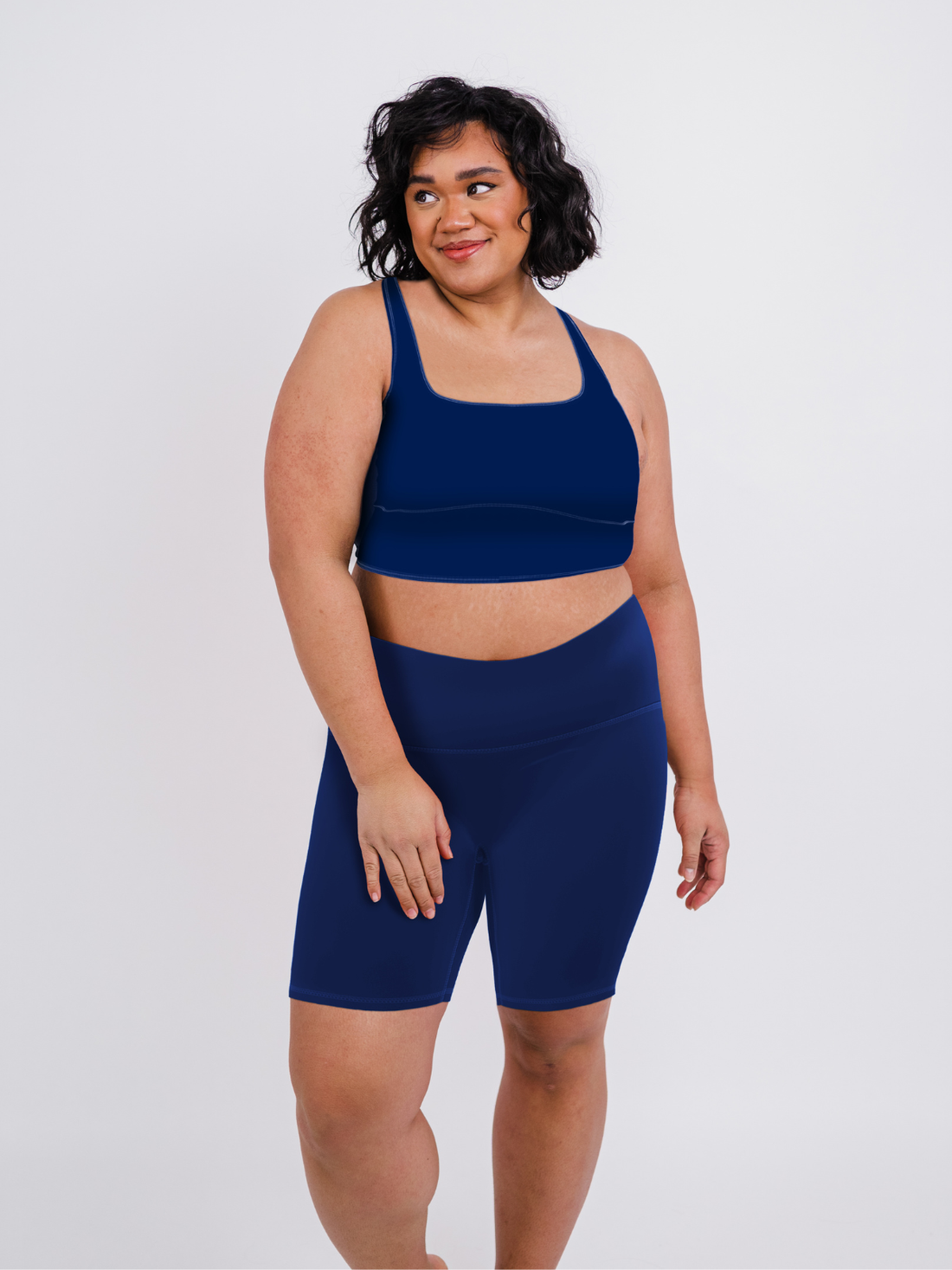 Woman wearing navy supportive long bike shorts paired with a matching swim top, highlighting Tummy Control Long Bike Swim Shorts | Plus Size, size-inclusive, modest swimwear with a comfortable fit for every body.